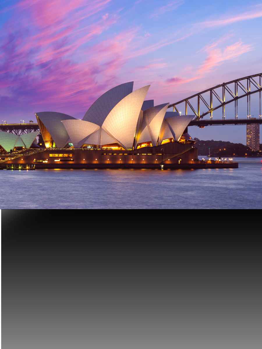 Sydney Opera House illuminated beside the harbour in Australia